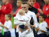 Rooney receives a plaque from Harry Kane (Nick Potts/PA)