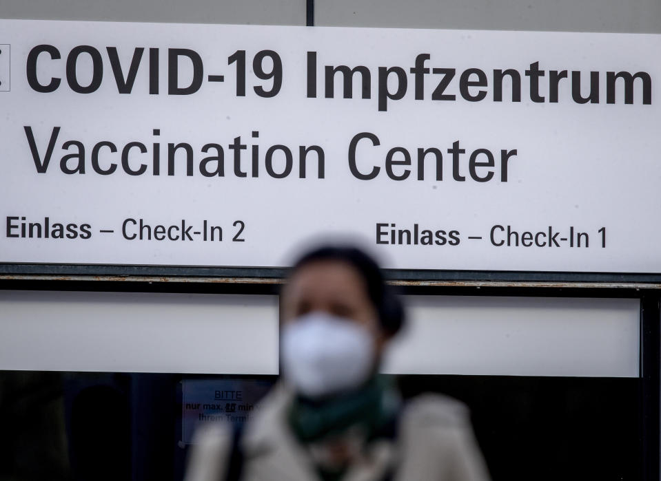 FILE - In this Thursday, Feb. 25, 2021 file photo, a woman walks past the entrance of the vaccination center in Frankfurt, Germany. Europe recorded 1 million new COVID-19 cases last week, an increase of 9% from the previous week and ending a six-week decline, WHO said Thursday, March 4, 2021. The so-called UK variant is of greatest concern in the 53 countries monitored by WHO in Europe. (AP Photo/Michael Probst, File)