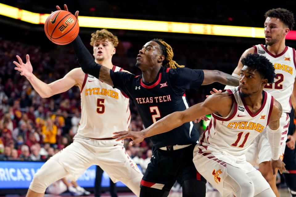 Texas Tech guard Davion Warren (2) fights for a loose ball with Iowa State forward Aljaz Kunc (5) and guard Tyrese Hunter (11) during the second half of an NCAA college basketball game, Wednesday, Jan. 5, 2022, in Ames, Iowa. (AP Photo/Charlie Neibergall) ORG XMIT: IACN121