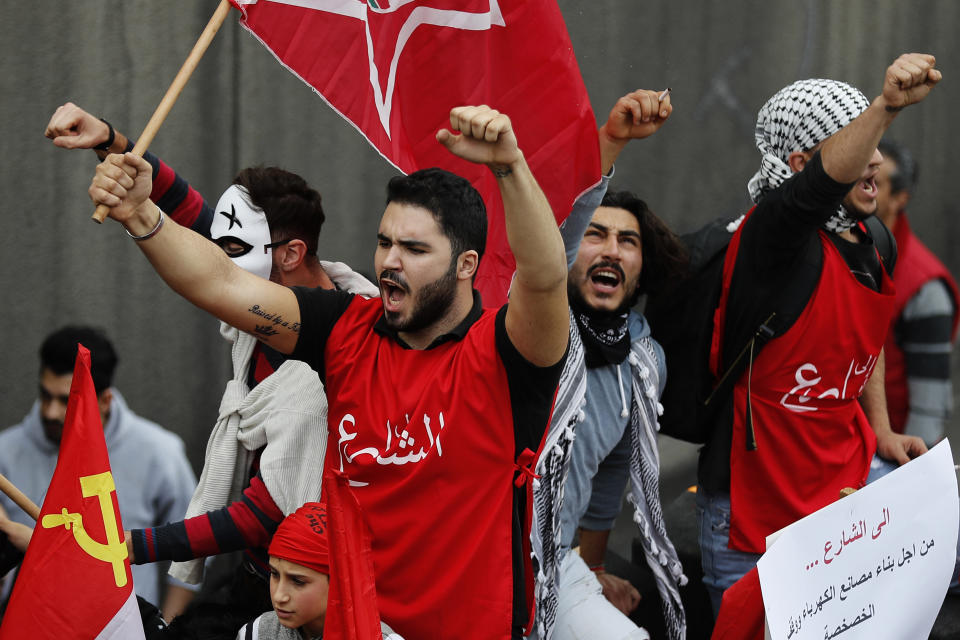Demonstrators shout slogans during a protest against the government organized by the country's communist party, in Beirut, Lebanon, Sunday, Dec. 16, 2018. Hundreds of Lebanese called for an end to a stalemate over forming a government seven months after elections. The Sunday protests were organized by the country's vibrant communist party, but drew others frustrated by the country's deepening economic and political crisis. (AP Photo/Hussein Malla)
