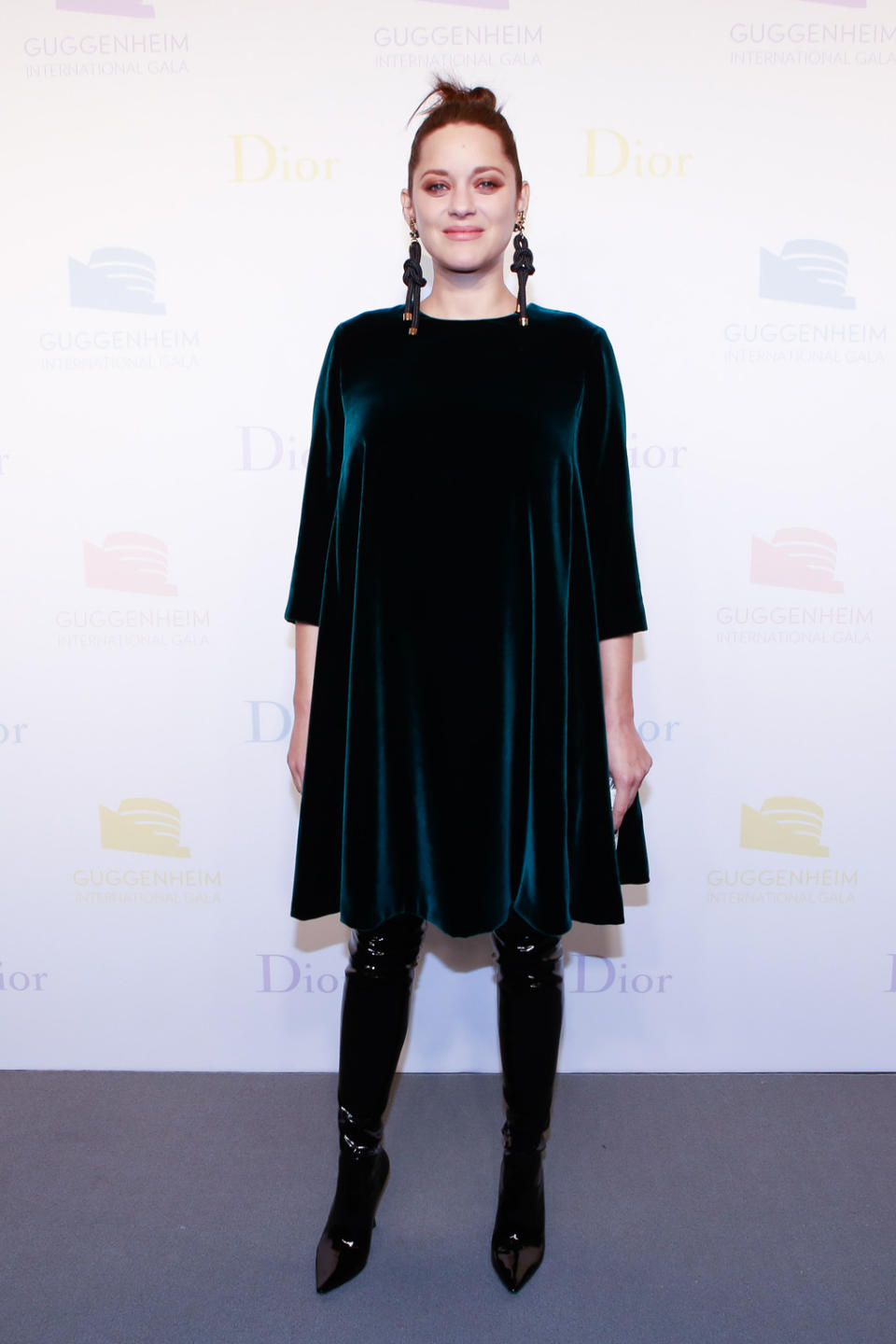 <p>Marion Cotillard turned out to the affair showing the girls just how to slay maternity style. The <em> Allied</em> actress paired a dark green silk velvet Dior dress with slick, high black boots and a clutch from the label. She finished off the look with statement rope earrings. </p>