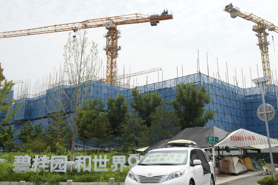A car with a sign that reads, "Country Garden homeowners rights protections 97 days," is parked near homeowners camping outside the Country Garden One World City project under construction on the outskirts of Beijing, Thursday, Aug. 17, 2023. China's government is trying to reassure jittery homebuyers after the major real estate developer missed a payment on its multibillion-dollar debt, reviving fears about the industry's shaky finances and their impact on the struggling Chinese economy. (AP Photo/Ng Han Guan)