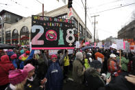 <p>A woman holds as sign as she takes part in a Women’s March in Seattle, Saturday, Jan. 20, 2018. The march was one of dozens planned across the U.S. over the weekend. (Photo: Ted S. Warren/AP) </p>