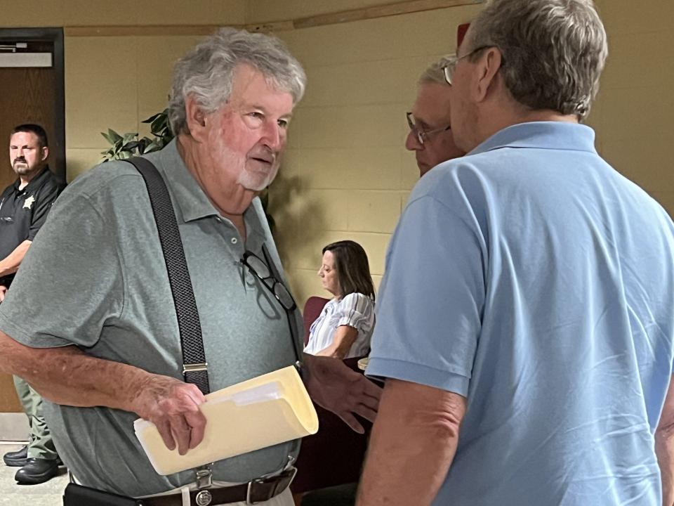 Drilling company owner Pete Peterson (left) speaks to attendees at a public meeting at Southeast Bulloch High School.