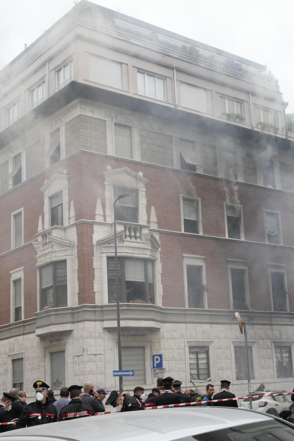 A view of a building that caught fire after a van exploded in central Milan, northern Italy, Thursday, May 11, 2023. (AP Photo/Luca Bruno)