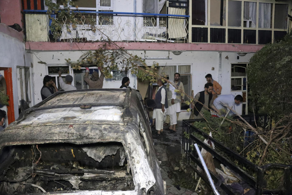 FILE - In this Sunday, Aug. 29, 2021 file photo, Afghans inspect damage of Ahmadi family house after U.S. drone strike in Kabul, Afghanistan. The Pentagon retreated from its defense of a drone strike that killed multiple civilians in Afghanistan last month, announcing Friday, Sept. 17, that a review revealed that only civilians were killed in the attack, not an Islamic State extremist as first believed. (AP Photo/Khwaja Tawfiq Sediqi, File)