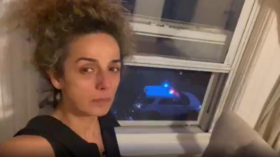 Iranian-American journalist Alinejad Masih shows an FBI car guarding outside her apartment in this still image from an undated social media video posted on July 14, 2021. (Twitter/@ALINEJADMASIH via Reuters)
