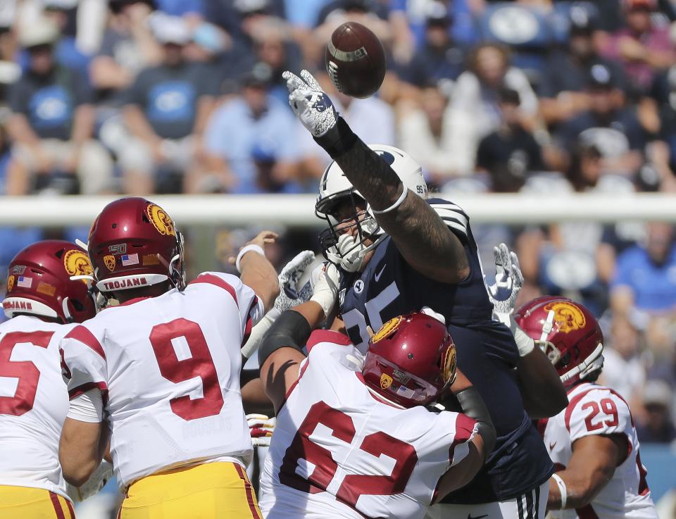 BYU defensive lineman Khyiris Tonga (95) blocks a pass by USC quarterback Kedon Slovis in Provo on Saturday, Sept. 14, 2019.