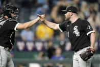 Chicago White Sox catcher Yasmani Grandal, left, and relief pitcher Liam Hendriks celebrate after their baseball game against the Kansas City Royals Monday, May 16, 2022, in Kansas City, Mo. The White Sox won 5-3 in ten innings. (AP Photo/Charlie Riedel)