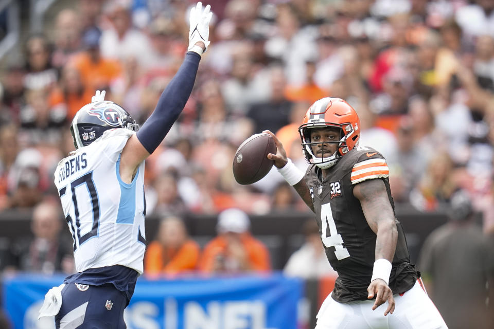 Tennessee Titans linebacker Jack Gibbens, left, pressures Cleveland Browns quarterback Deshaun Watson (4) during the first half of an NFL football game Sunday, Sept. 24, 2023, in Cleveland. (AP Photo/Sue Ogrocki)