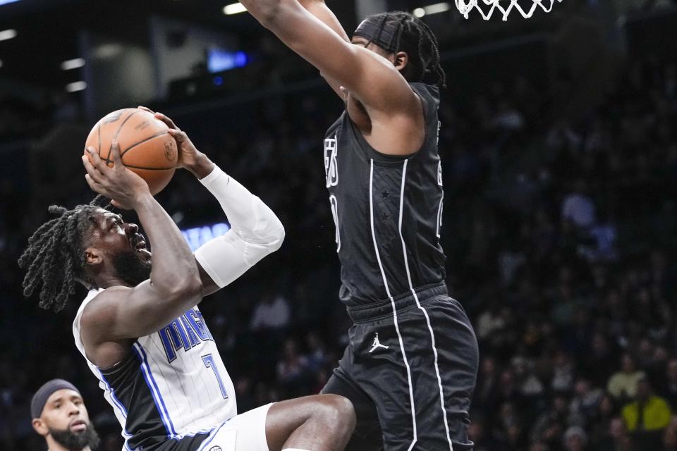 Orlando Magic guard Kevon Harris (7) goes to the basket against Brooklyn Nets center Day'Ron Sharpe during the first half of an NBA basketball game Friday, April 7, 2023, in New York. (AP Photo/Mary Altaffer)