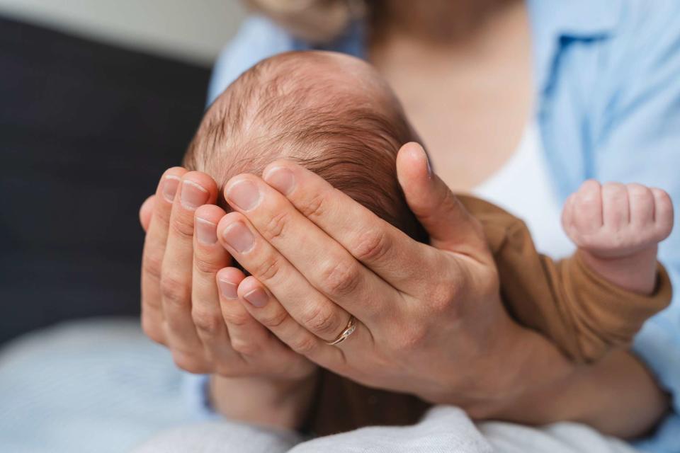 <p>Getty</p> Stock image of Mother holding baby boy in hands at home