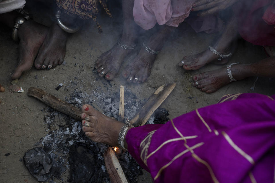 Indian pilgrims make themselves warm as they wait to embark on a visit to the sacred Pashupatinath temple in Kathmandu, Nepal, Jan. 10, 2024. The centuries-old temple is one of the most important pilgrimage sites in Asia for Hindus. Nepal and India are the world’s two Hindu-majority nations and share a strong religious affinity. Every year, millions of Nepalese and Indians visit Hindu shrines in both countries to pray for success and the well-being of their loved ones. (AP Photo/Niranjan Shrestha)