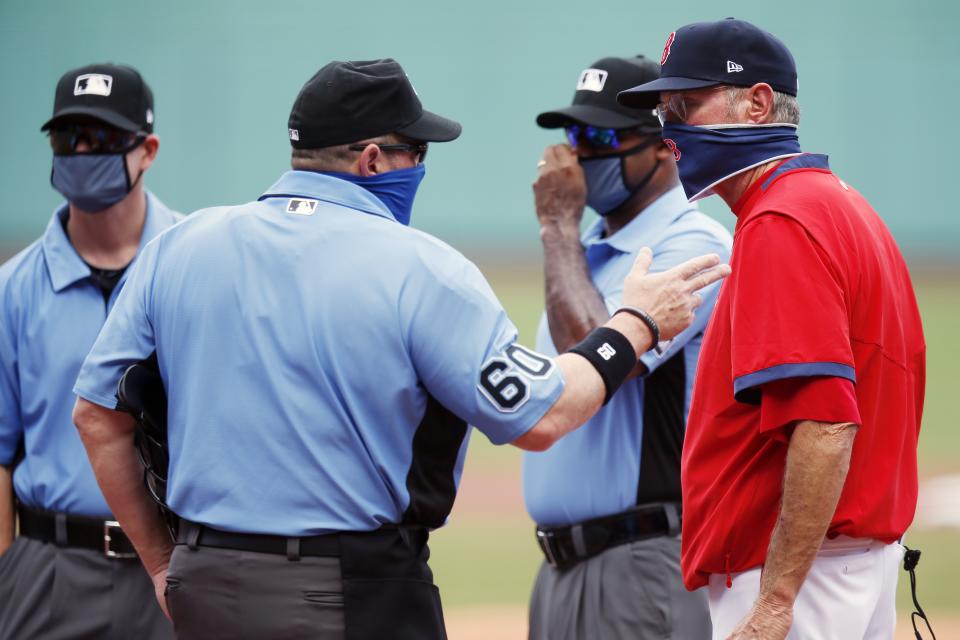 Boston Red Sox manager Ron Roenicke, right, talks with home plate umpire Marty Foster (60) before a baseball game against the Baltimore Orioles, Saturday, July 25, 2020, in Boston. (AP Photo/Michael Dwyer)