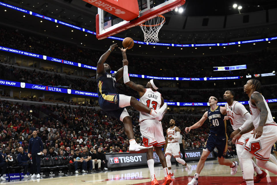 New Orleans Pelicans' Zion Williamson (1) goes up for a shot while being fouled by Chicago Bulls' Torrey Craig (13) during the second half of an NBA basketball game Saturday, Dec. 2, 2023, in Chicago. Chicago won 124-118. (AP Photo/Paul Beaty)