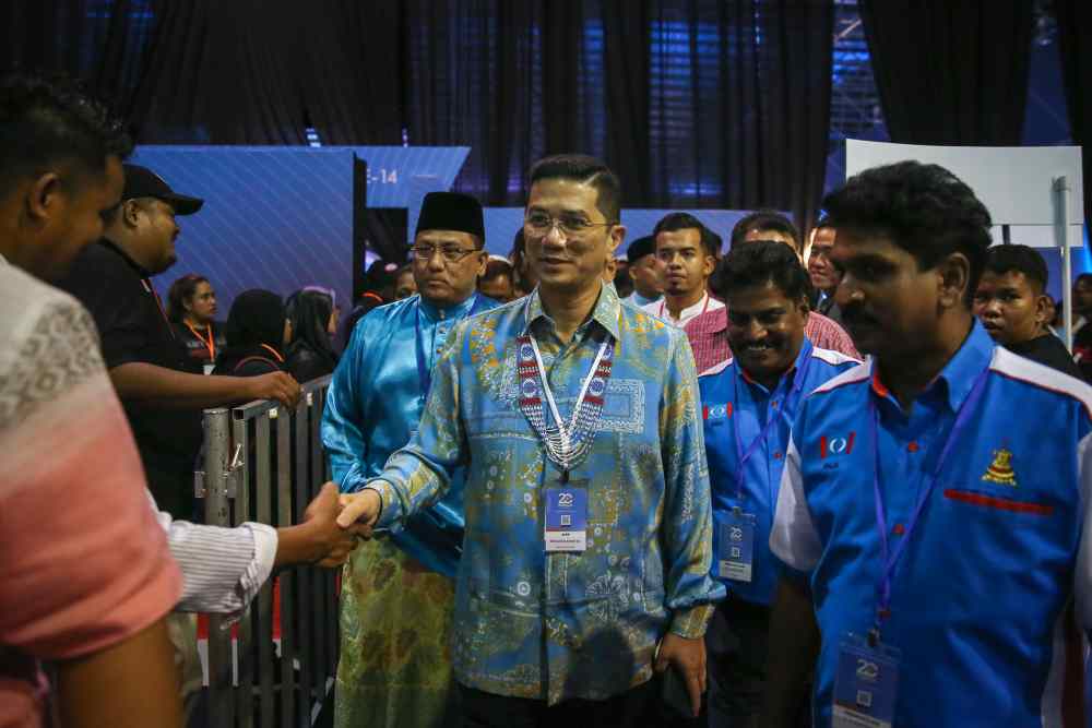 PKR deputy president Datuk Seri Mohamed Azmi Ali greets party members during the 2019 PKR National Congress in Melaka December 7, 2019. ― Picture by Yusof Mat Isa