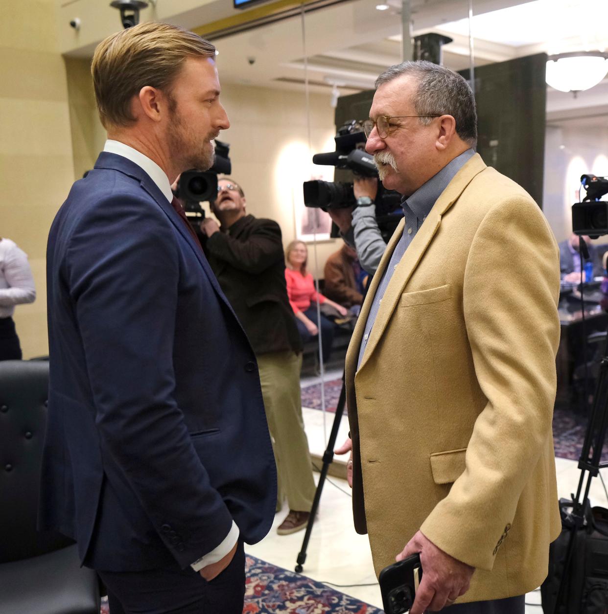 Oklahoma state schools Superintendent Ryan Walters, left, and House education subcommittee Chairman Mark McBride speak Jan. 10 before a budget hearing at the Oklahoma Capitol.