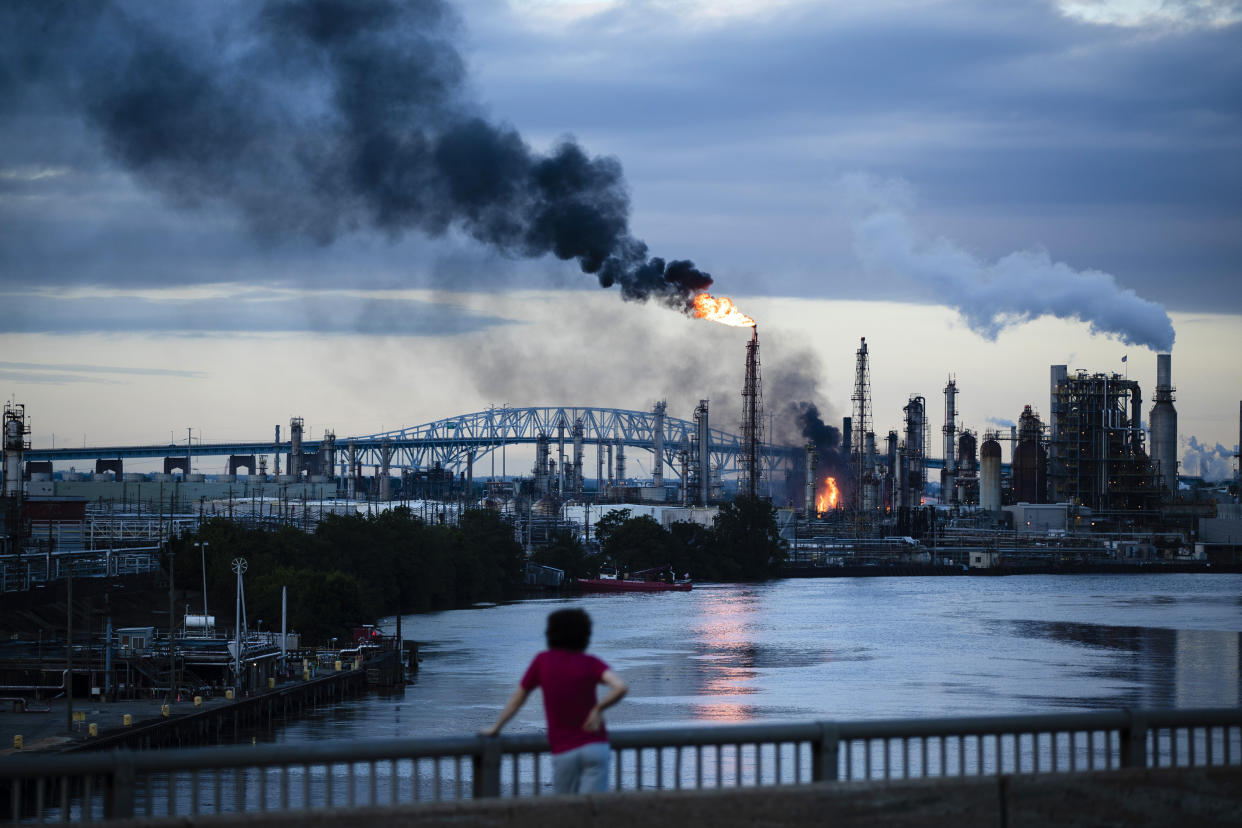 A South Philly resident watches as the Philadelphia Energy Solutions refinery goes up in flames on June 21.&nbsp;&nbsp; (Photo: Matt Rourke/ASSOCIATED PRESS)