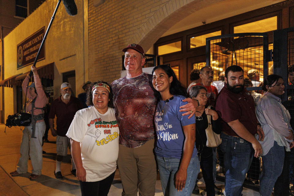 Cody Smith, center, poses for pictures with his opponents Veronica Martinez and Kimberly Mata-Rubio after the election results were announced on Tuesday evening, Nov. 7, 2023, in Uvalde, Texas. In Uvalde’s first mayoral race since the Robb Elementary School shooting, Smith won back the job Tuesday. (Sam Owens/The San Antonio Express-News via AP)