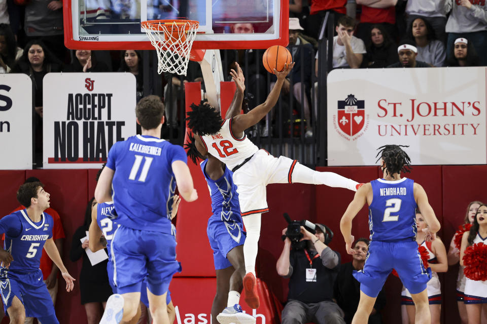 St. John's guard Kolby King (12) draws a foul against Creighton forward Arthur Kaluma as center Ryan Kalkbrenner (11), and guard Ryan Nembhard (2) watch during the first half of an NCAA college basketball game Saturday, Feb. 18, 2023, in New York. (AP Photo/Jessie Alcheh)