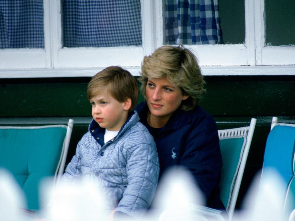 Princess William sits in Princess Diana's lap at a polo match in 1987.