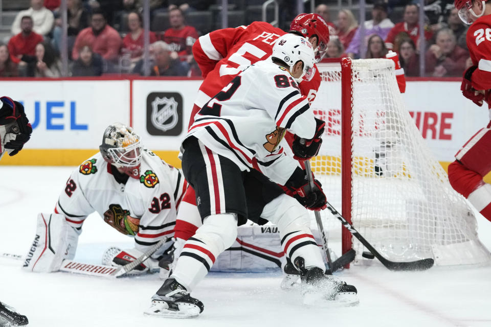 Chicago Blackhawks goaltender Alex Stalock (32) stops a Detroit Red Wings left wing David Perron (57) shot in the second period of an NHL hockey game Wednesday, March 8, 2023, in Detroit. (AP Photo/Paul Sancya)