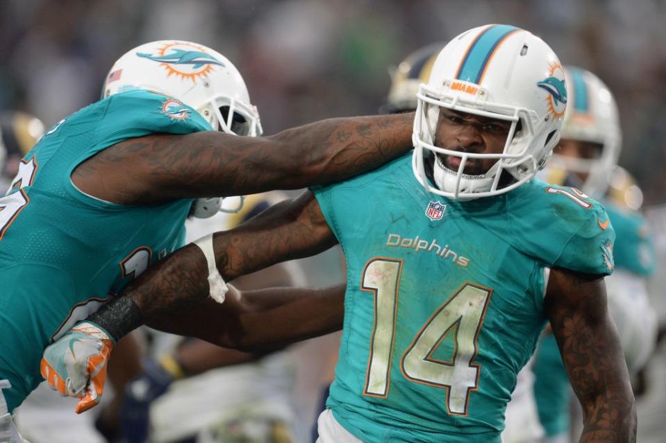 November 20, 2016; Los Angeles, CA, USA; Miami Dolphins wide receiver Jarvis Landry (14) celebrates with running back Damien Williams (26) his touchdown scored against the Los Angeles Rams during the second half at Los Angeles Memorial Coliseum. Mandatory Credit: Gary A. Vasquez-USA TODAY Sports