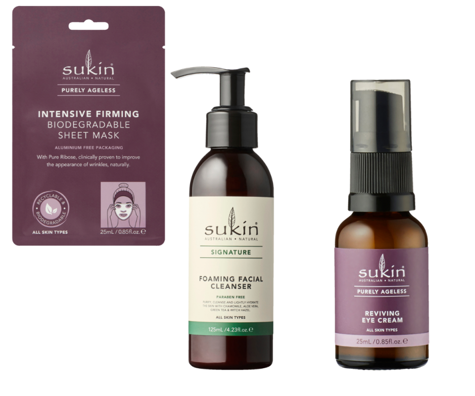 A purple Sukin face sheet mask, a brown bottle cleanser with a cream label and a brown bottle eye cream with a purple label on a white background.