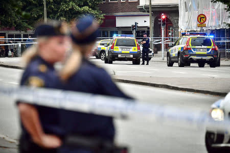 Police stand next to a cordon after a shooting on a street in central Malmo, Sweden June 18, 2018. TT News Agency/Johan Nilsson/via REUTERS