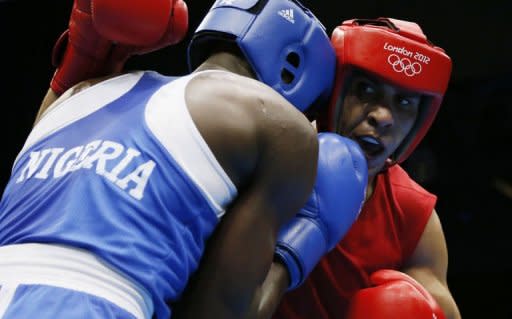 Ihab Almatbouli (R) of Jordan exchanges blows with Lukmon Lawal (L) of Nigeria during their first round Light-heavyweight (81kg) match of the London 2012 Olympic Games at the Excel Arena in London. Almatbouli fought to a 19-7 points decision