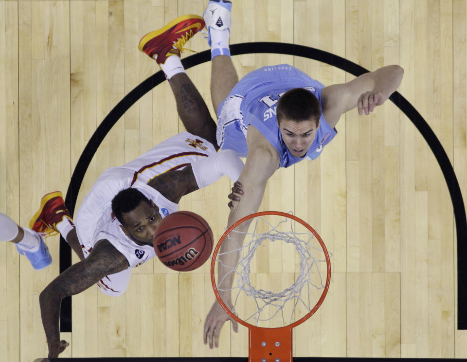 Iowa State's DeAndre Kane, left, makes the winning shot over North Carolina's Jackson Simmons, right, in the final seconds of the second half of a third-round game in the NCAA college basketball tournament Sunday, March 23, 2014, in San Antonio. Iowa State won 85-83. (AP Photo/Eric Gay)