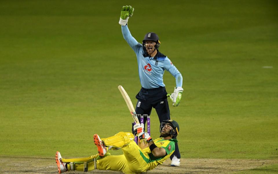 Glenn Maxwell of Australia falls over whilst attempting a reverse sweep as Jos Buttler of England appeals for LBW during the 3rd Royal London One Day International Series match between England and Australia at Emirates Old Trafford on September 16, 2020 - GETTY IMAGES