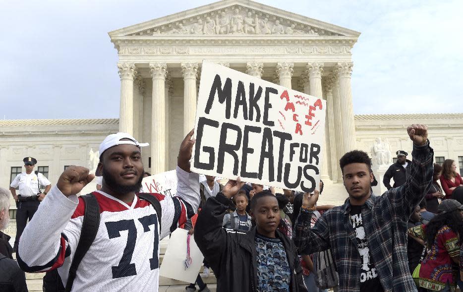 FILE - In this Tuesday, Nov. 15, 2016 file photo, high school students protest outside the Supreme Court building in Washington. Hundreds gathered to protest Donald Trump's election, mostly young people who appear to have walked out of school to protest. The news in 2016 was filled with battles over culture and territory that exposed divisions far deeper than many realized. (AP Photo/Susan Walsh)