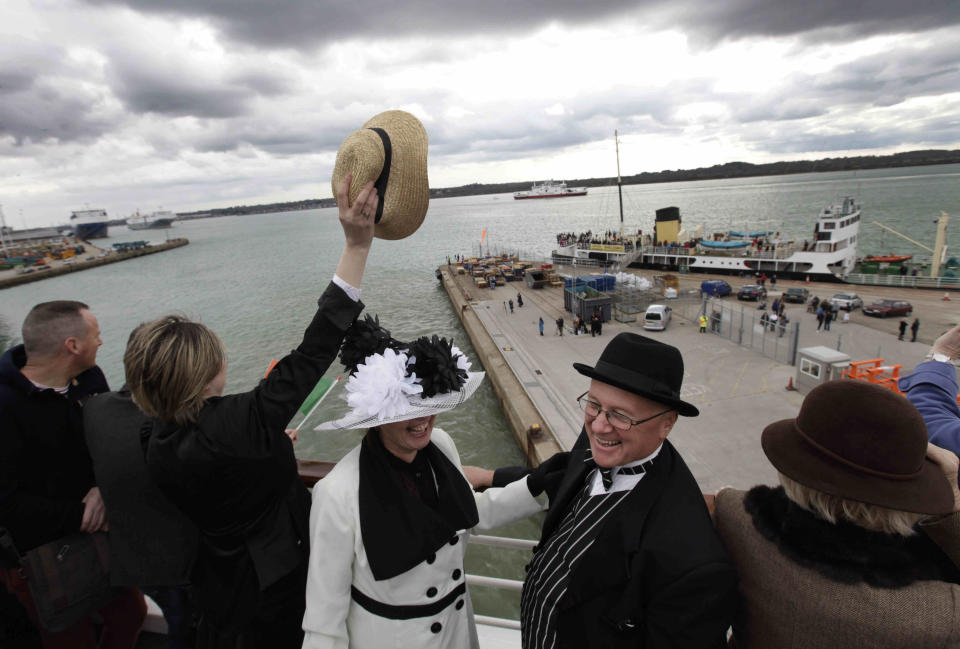 Passengers, some wearing costumes, wave goodbye, as the MS Balmoral Titanic memorial cruise ship sail from Southampton, England, on Easter Sunday, April 8, 2012. Nearly 100 years after the Titanic went down, a cruise with the same number of passengers aboard is setting sail to retrace the ship's voyage, including a visit to the location where it sank. The Titanic Memorial Cruise departed Sunday from Southampton, where the Titanic left on its maiden voyage and the 12-night cruise will commemorate the 100th anniversary of the sinking of the White Star liner. With 1,309 passengers aboard, the MS Balmoral will follow the same route as the Titanic and organizers are trying to recreate the onboard experience minus the disaster from the food to a band playing music from that era. (AP Photo/Lefteris Pitarakis)