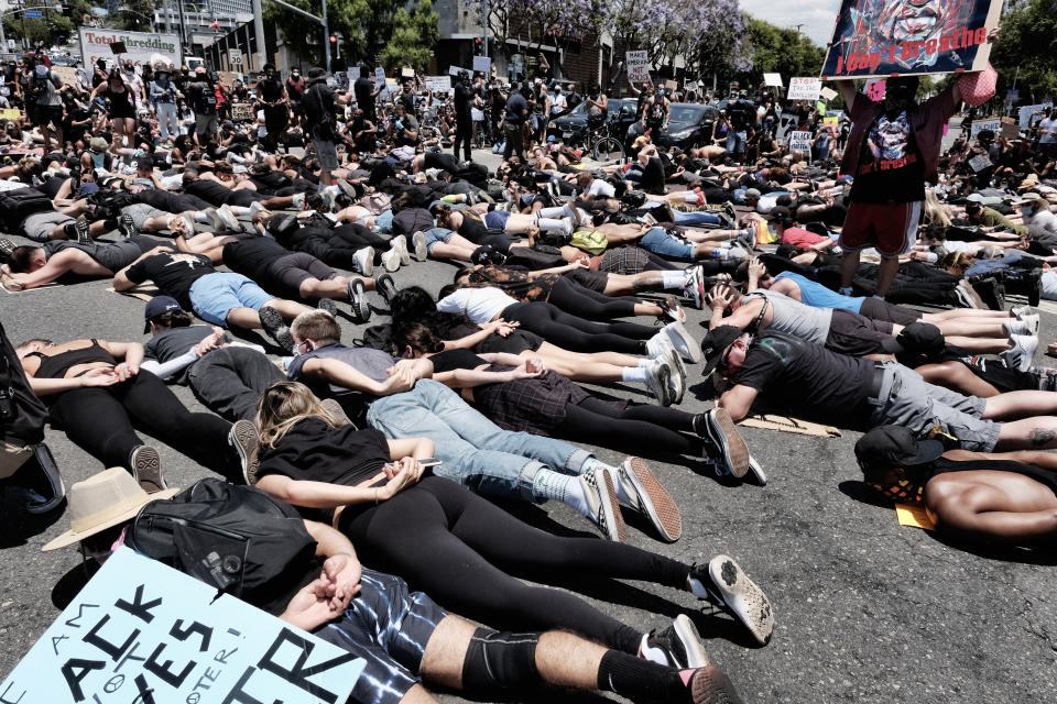 LGBTQ community members join Black Lives Matter protesters as they block an intersection laying on the street with their hands behind their backs in West Hollywood, Calif. on Wednesday, June 3, 2020, over the death of George Floyd. Floyd, a black man died after being restrained by Minneapolis police officers on May 25. (AP Photo/Richard Vogel)