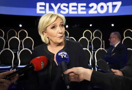 Marine Le Pen of French National Front (FN) poses at the television studio where the eleven candidates will attend a prime-time televised debate for the French 2017 presidential election in La Plaine Saint-Denis, near Paris, France, April 4, 2017. REUTERS/Lionel Bonaventure/Pool