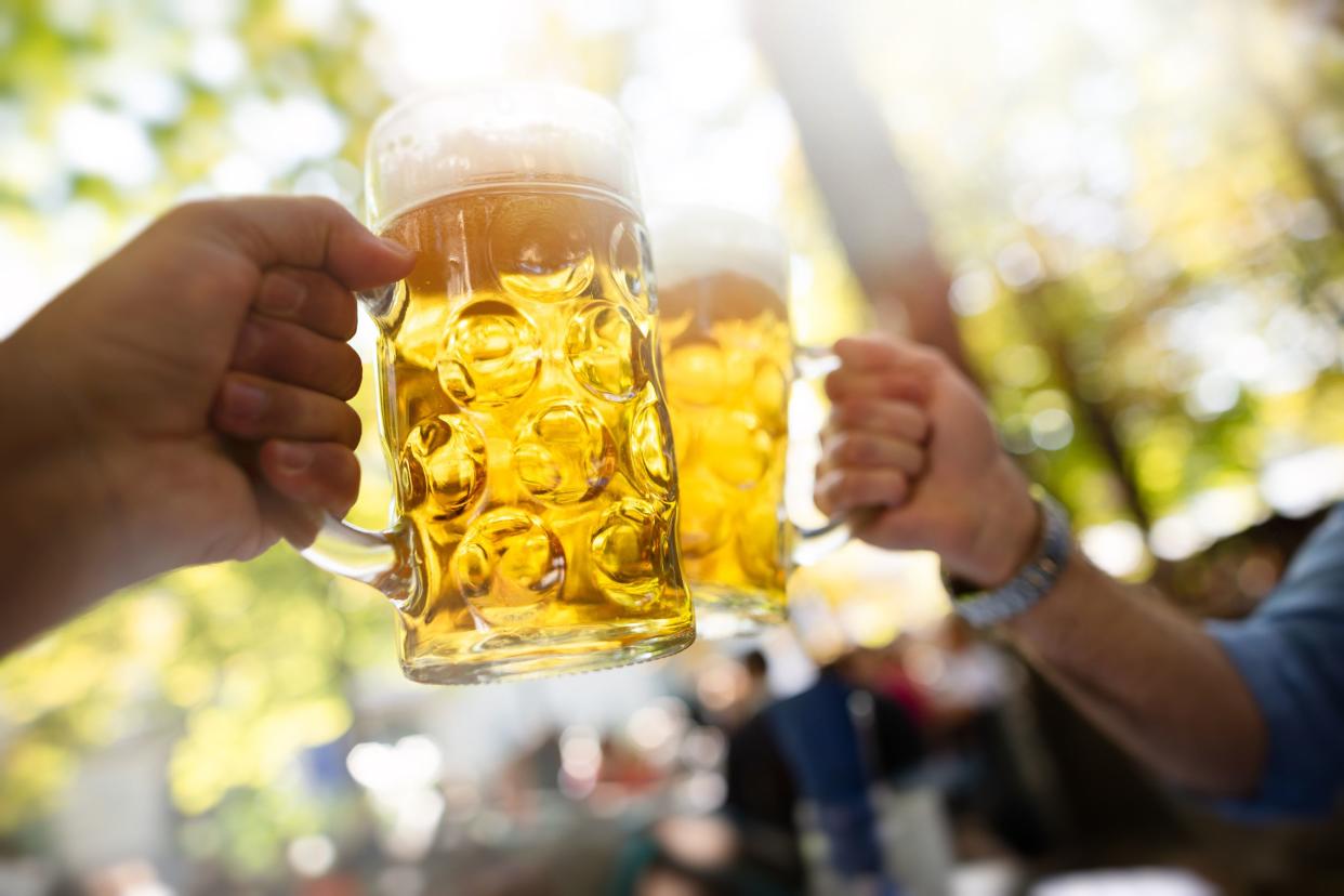 two men cheering beer at beer garden