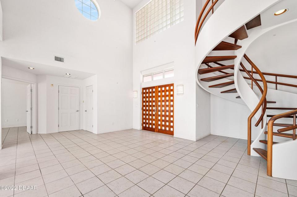 This custom-built spiral staircase not only leads to the second floor, it stands out as a centerpiece of the foyer.