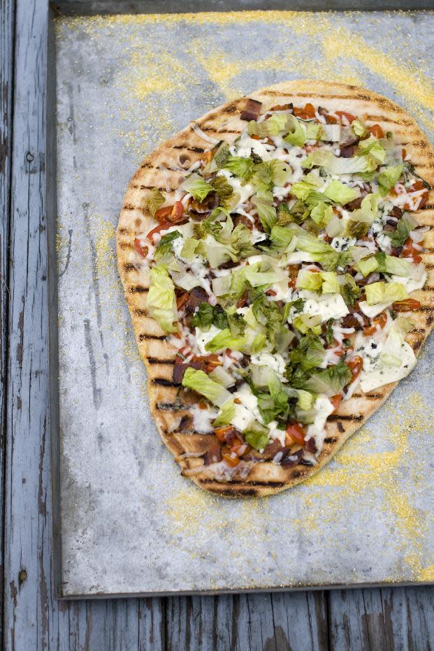 This July 22, 2013 photo taken in Concord, N.H., shows a recipe for grilled BLT pizza with summer tomato-basil sauce. (AP Photo/Matthew Mead)