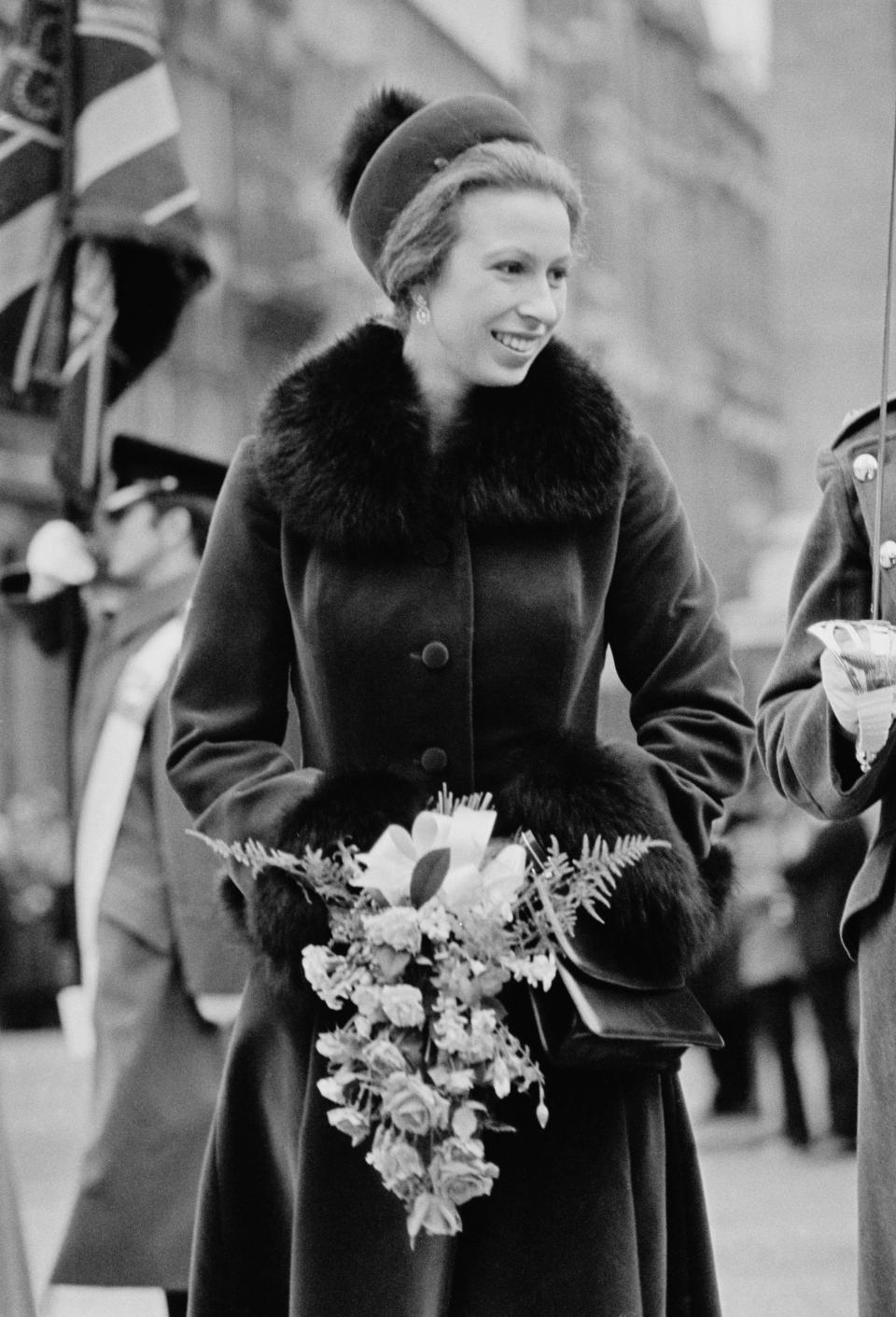 Princess Anne, attends a formal event wearing long coat with fur details in 1976. (Getty Images)