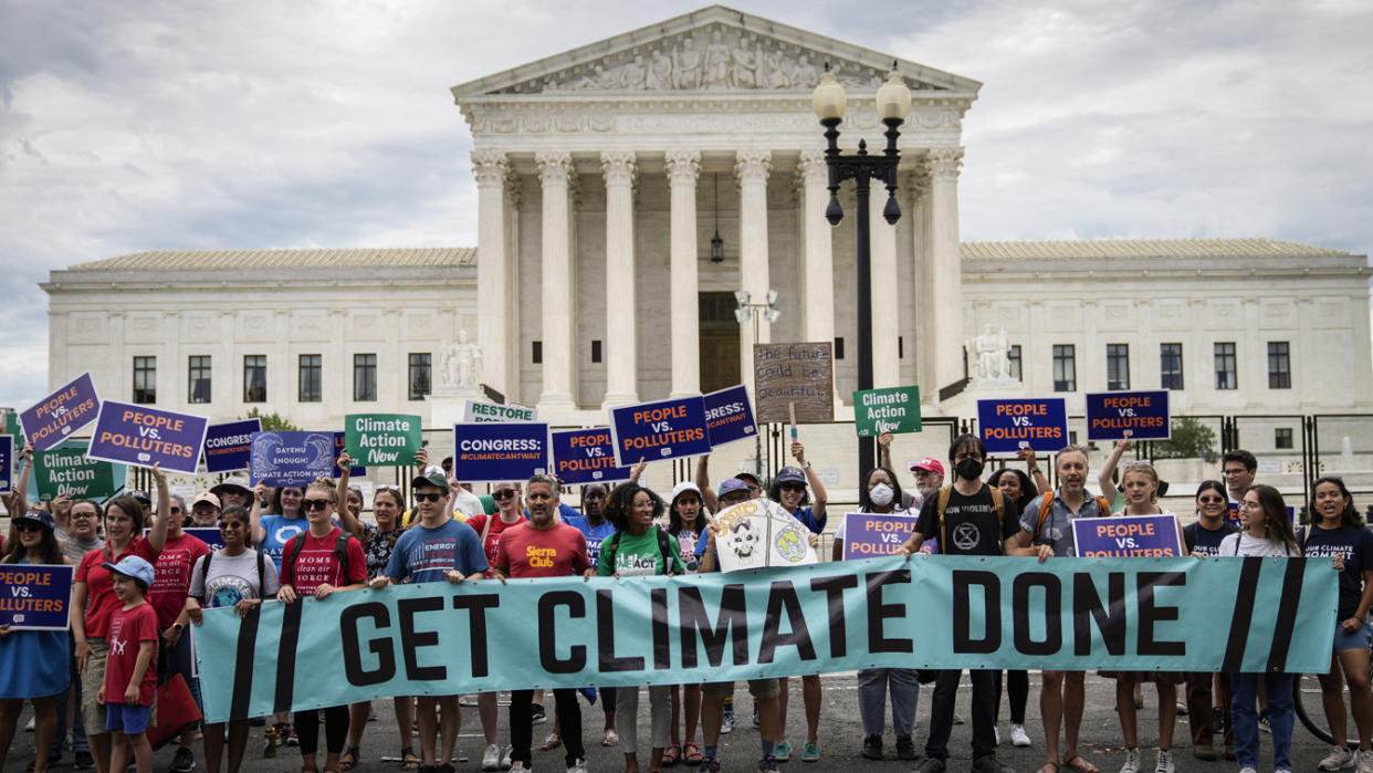 Environmental activists rally in front of the Supreme Court