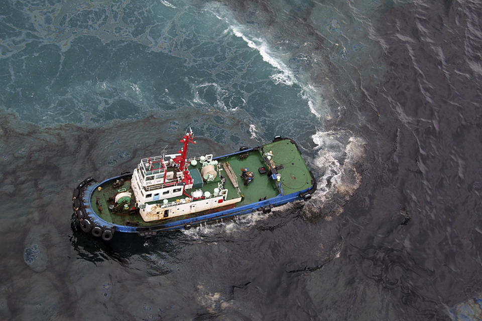 In this photo taken Saturday, July 27, 2013, a cleaning vessel clears the oil after about 50 tons of crude oil was leak from a pipe spilled into the sea off Rayong province, eastern Thailand. The oil spill that leaked from a pipeline, operated by a subsidiary of state-owned oil and gas company PTT Plc, has reached a popular tourist island in Thailand's eastern sea despite continuous attempts to clean it up over the weekend, officials said Monday. (AP Photo/The Nation-Atchara) THAILAND OUT