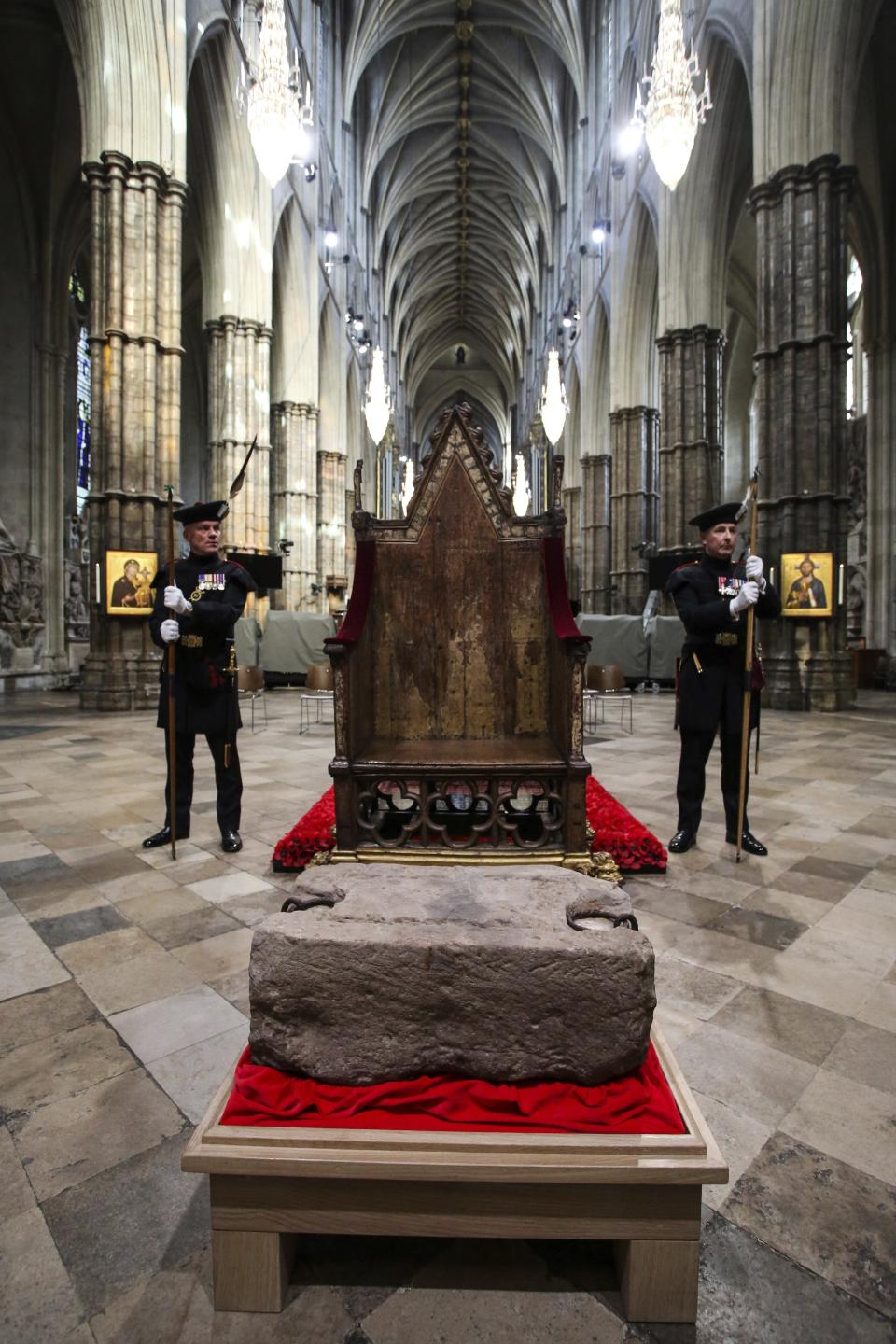 King's Bodyguards for Scotland and members of Royal Company of Archers Alex Baillie-Hamilton, left, and Paul Harkness stand guard by the Stone of Destiny, during a welcome ceremony ahead of the coronation of Britain's King Charles III, in Westminster Abbey, London, Saturday, April 29, 2023. (Susannah Ireland/Pool Photo via AP)