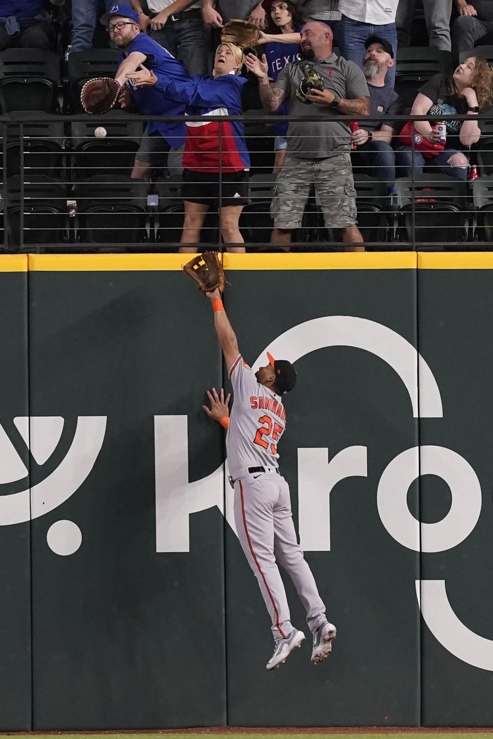 Baltimore Orioles right fielder Anthony Santander (25) and fans in the outfield can't reach the two-run home run hit by Texas Rangers' Josh Jung during the sixth inning of a baseball game in Arlington, Texas, Wednesday, April 5, 2023. (AP Photo/LM Otero)