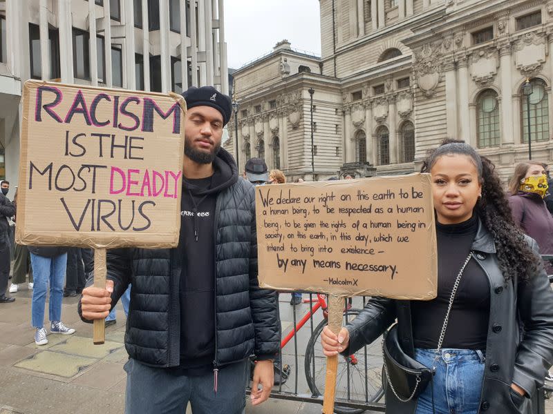 Demonstrators hold signs during a Black Lives Matter protest in Parliament Square, following the death of George Floyd who died in police custody in Minneapolis, in London