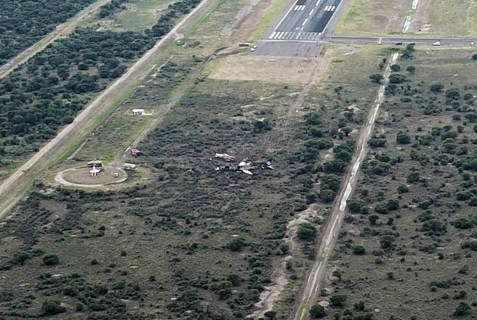 <p>Picture showing the wreckage of a plane (C) that crashed with 97 passengers and four crew on board on take off at the airport of Durango, in northern Mexico, on July 31, 2018. – Dozens of Picture showing the wreckage of a plane (C) that crashed with 97 passengers and four crew on board on take off at the airport of Durango, in northern Mexico, on July 31, 2018. (Photo: Kevin Alcantar/Kevin Alcantar Drones Durango/AFP/Getty Images) </p>