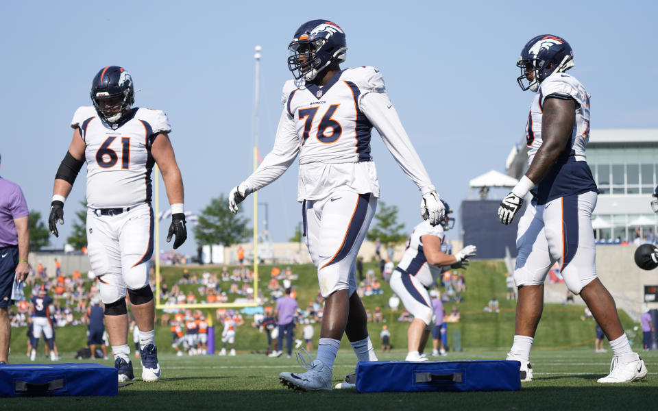 From left, Denver Broncos offensive guard Graham Glasgow, offensive tackle Calvin Anderson and offensive tackle Bobby Massie take part in drills during an NFL football training camp at the team's headquarters Wednesday, Aug. 18, 2021, in Englewood, Colo. (AP Photo/David Zalubowski)