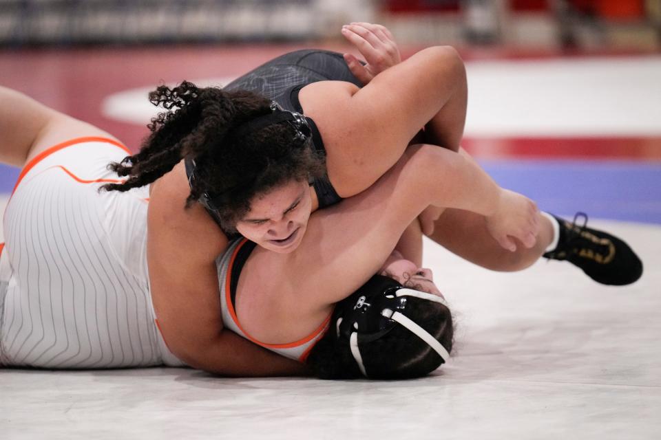 Marysville’s Desi Lee, top, competes against Olentangy Orange’s Jenny Huaracha-Arellanos during the girls state duals Sunday at Marysville.