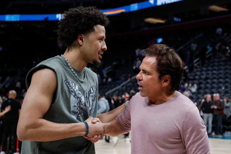 Detroit Pistons guard Cade Cunningham talks with Pistons owner Tom Gores after the Pistons lost 123-108 to the Brooklyn Nets in the home finale at Little Caesars Arena in Detroit on Wednesday, April 5, 2023.