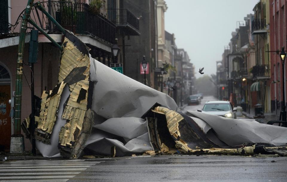 A section of roof that was blown off of a building in the French Quarter by Hurricane Ida winds blocks an intersection, Sunday, Aug. 29, 2021, in New Orleans.